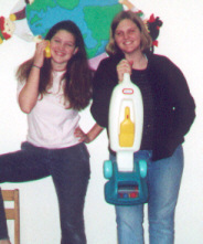 tif and liz! holding the vaccum cleaner