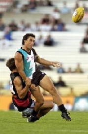 Roger James gets his kick away while under pressure