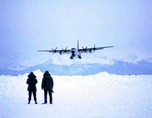 A Navy C-130 on skis about to land on snow 