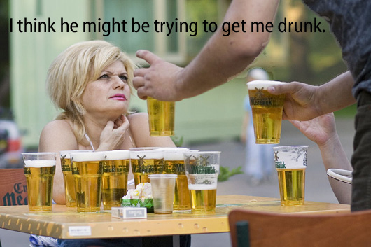 [man giving woman 2 beer glasses when it appears she already has around a dozen] I think he might be trying to get me drunk.