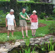 Picture of neighbors discussing lovely landscaped pond