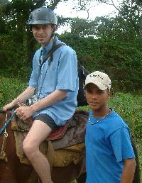 Sean on his crap horse, and Memos, Karolinas little helper. Photograph (c) Karolina Karlsson 2004