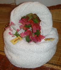 Towel sculpture and flowers in the room. Photograph (c) Karolina Karlsson 2004