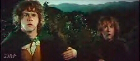 Merry and Pippin in tree looking at Sarumans army