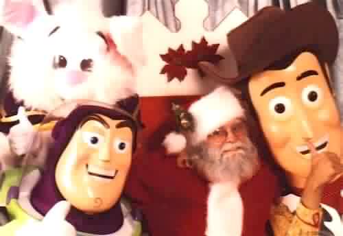 Santa B Claus posing with the characters from the movie "Toys"