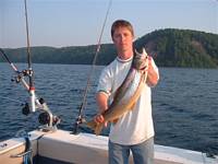Captain George Malyuk on board the Lida Rose in the apostle islands with a nice brown trout.