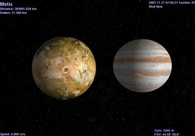 Jupiter's volcanic major satellite Io & minor satellite Metis (background).