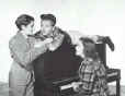 Ronald Sinclair, Mickey Rooney, and Judy Garland on the set of Thoroughbreds Don't Cry