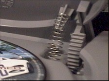 Spring keeps door switch closed