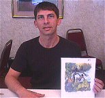 Chris Schenck displays some of his Tarzan art