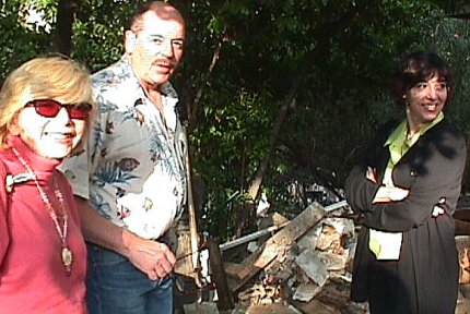 Mary, Danton and Stacy examining house expansion project