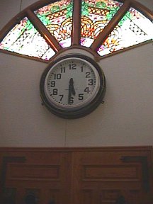 Clock and stained glass window above the main door