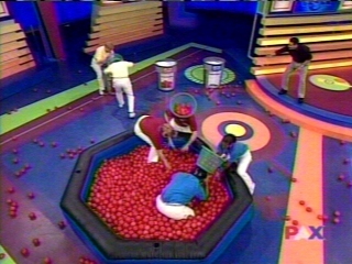 The teams scoop balls into their bins to earn control