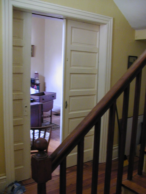 peeking through the pocket doors into the living room