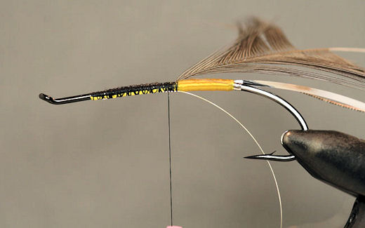 I also like to tie in a piece of fine silver wire at this point to use as a counter rib to reinforce the hackle.