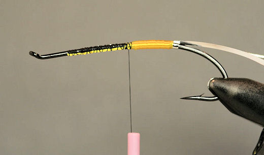 Next wrap the floss about third of the way up the hook shank and tie it off.