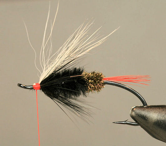 Tie in a small bunch of polar bear hair or substitute (goat, calftail, bucktail or skunk make a great wing for this fly), then trim the excess.