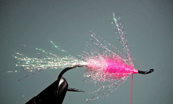 7. Evenly stroke the Krystal Flash back over the eye of the hook and wrap the base of the fibers so you have "hackled" the fly with the reversed strands. I make a smooth thread base for the soft hackle to follow over the Krystal Flash.