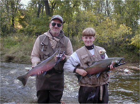 Father and Son fishing the Sheboygan River during the fall salmon run 2001. Pat Mertens and son Joe Mertens holding Coho caught at the same time.
