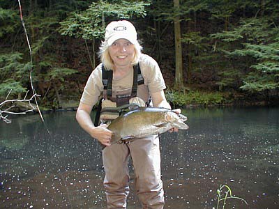 Amy Gablick displaying a beautiful rainbow caught last spring on a Pennsylvania river.