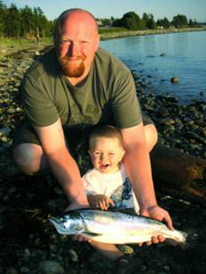 Stuart and his son with his first salmon