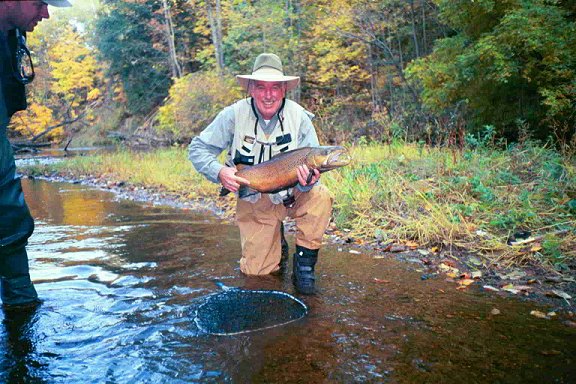 Don Edwards with a salmon-sized Brown Trout caught with a Green Caddis on the White River in Michigan in the Fall of 2003.