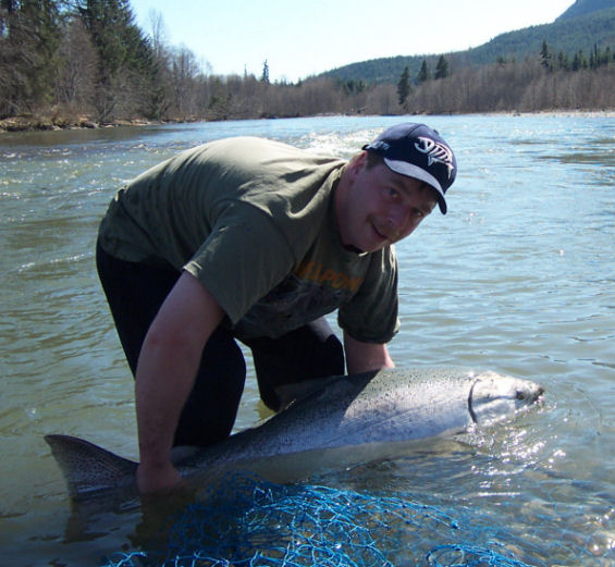 James DeProy fishing Kalum river Terrace B.C., revives a huge chrome king April 29 2006.
