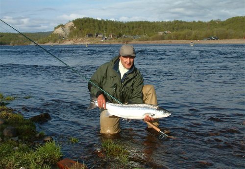 Contributing Fly Tyer, Yuri Shumakov, with a beautiful Atlantic Salmon about to be released back to the Ujama pool, Kola River, Russia.