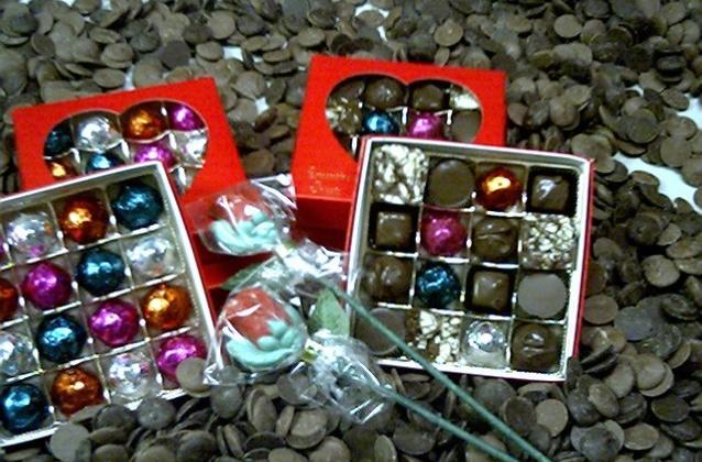 Valentine truffles and assorted chocolates shown with long stem chocolate roses