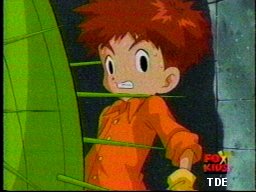 Kou, pressed against the wall from Togemon's sudden evolution, catches Mimi's glance...