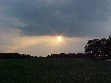 Image of sunshine peeking out from storm clouds.